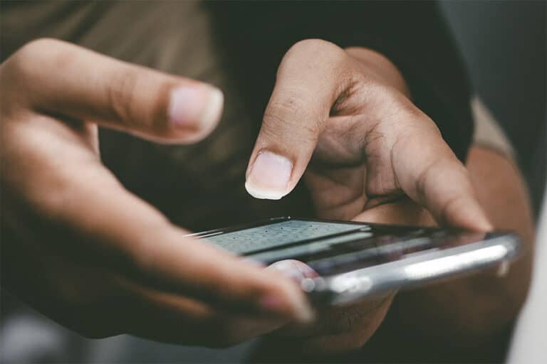 FBC-PERSON TEXTING A MESSAGE ON THEIR MOBILE PHONE